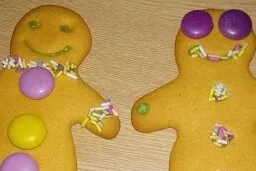 A couple of gingerbread people holding hands