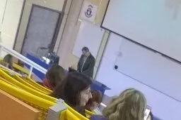 Photo of the stage in a lecture Theatre during a lecture